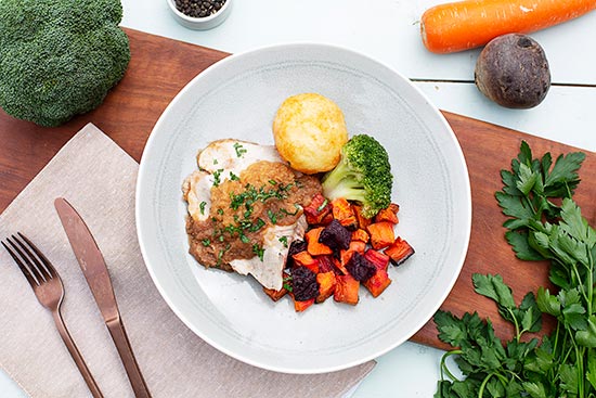Plate of Roast Pork & Sweet Apple Sauce on a wooden board