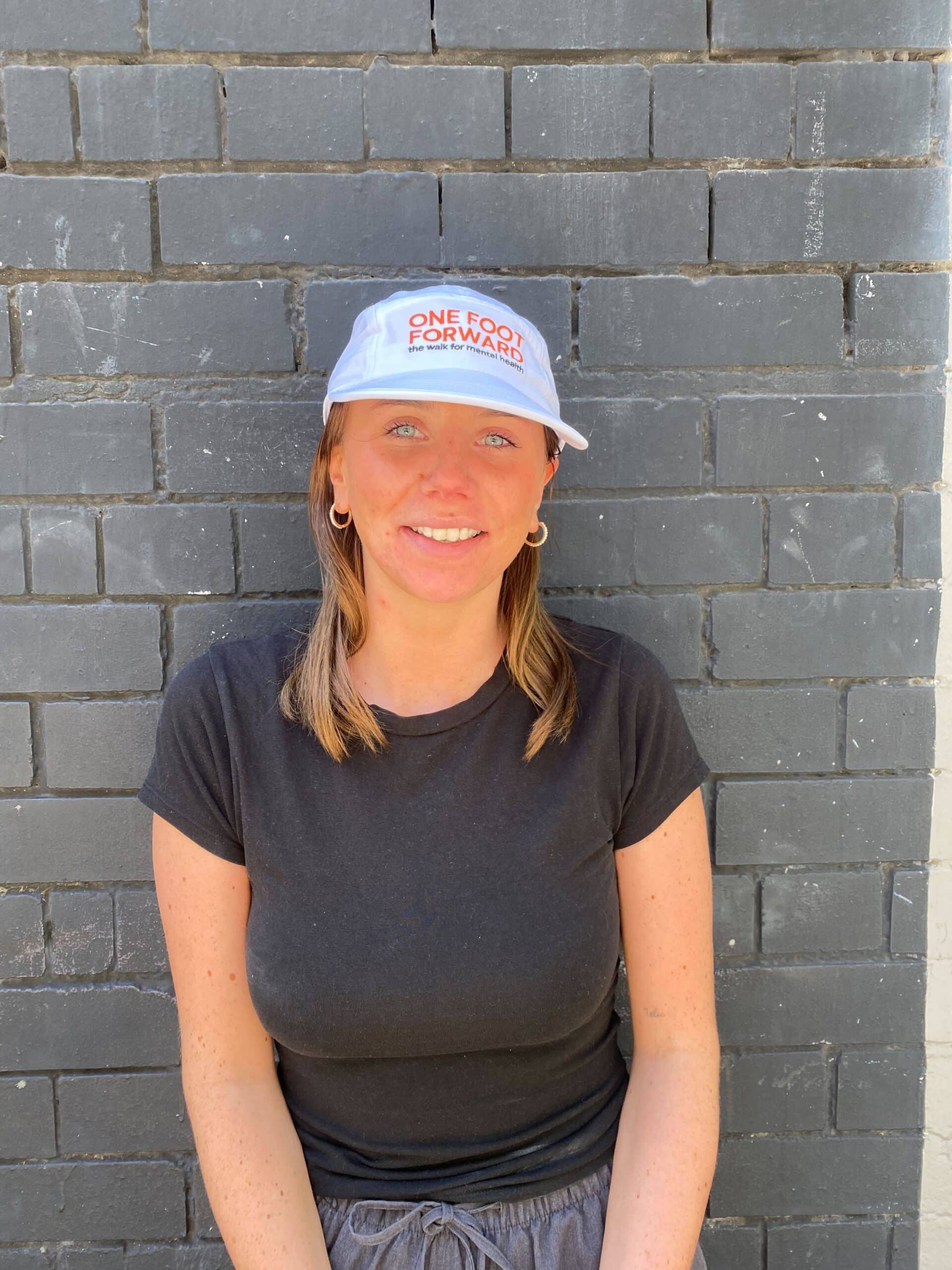 Tabiitha wearing a blue One Foot Forward cap