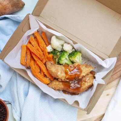 crumbed chicken tenders with sweet and sour sauce above