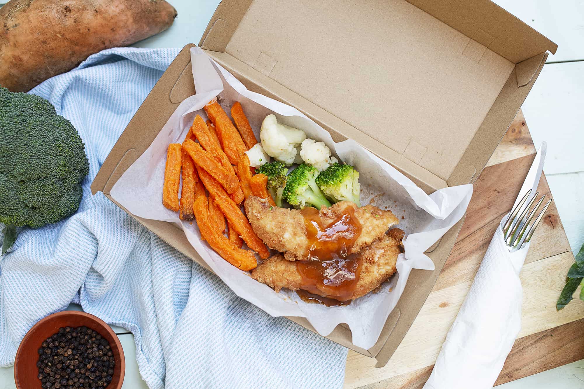crumbed chicken tenders with sweet and sour sauce above